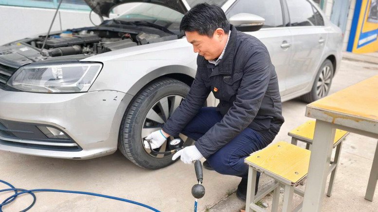 汽车工程学院党员教师为教职工车辆充气